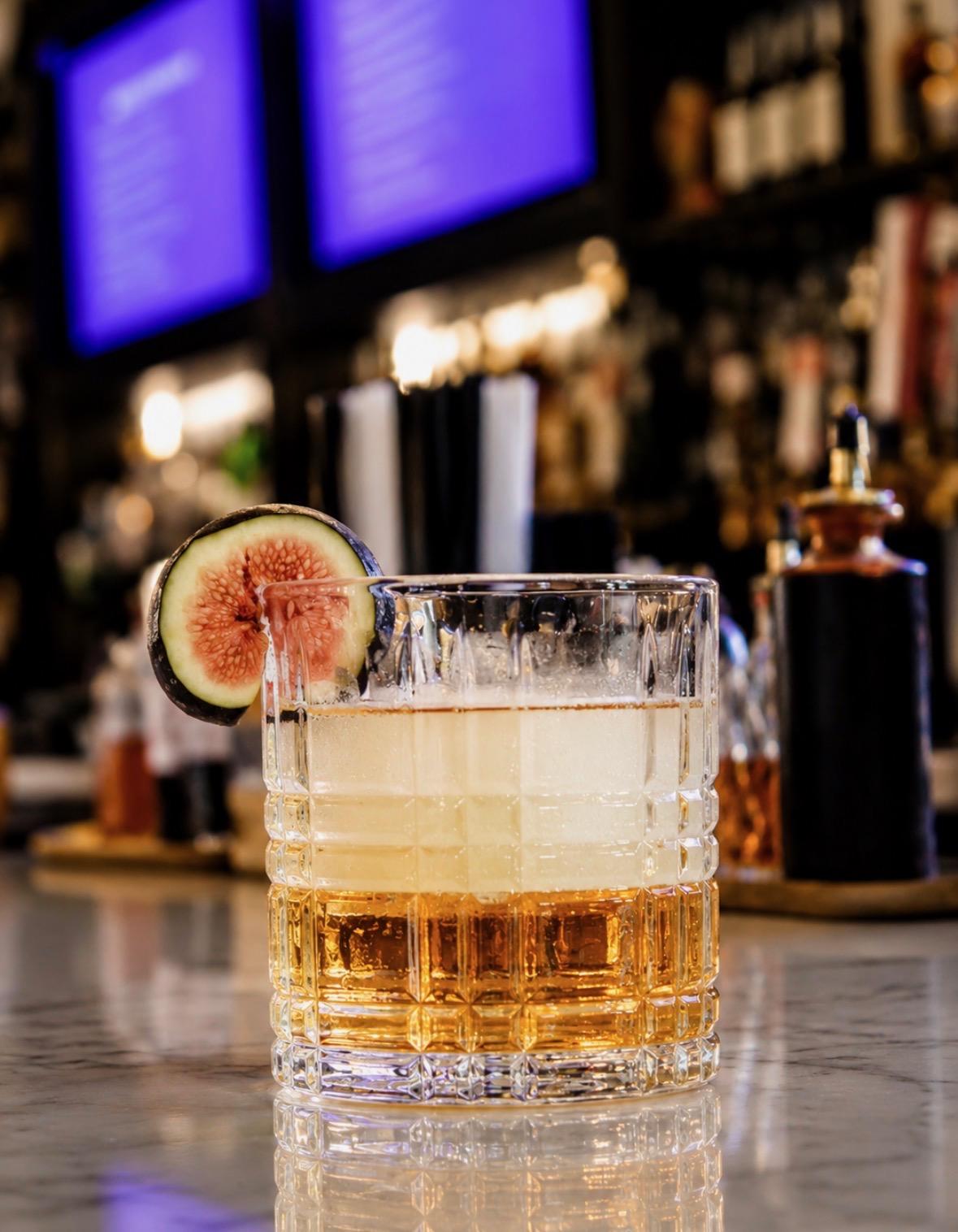 A whiskey cocktail garnished with fig at the Fairways at GLC bar