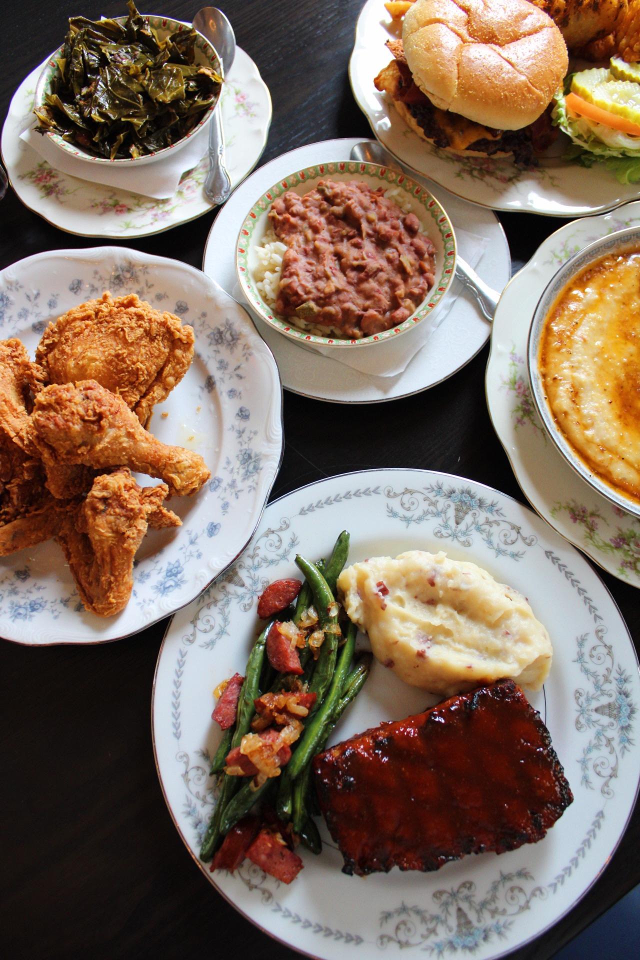A table spread of fried chicken, ribs, burger, and Lowcountry sides at Fairways at GLC